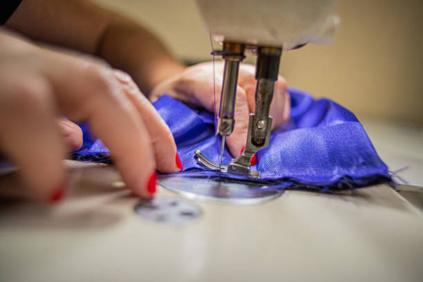 Close-up of a woman's hands sewing a pants using the sewing machine