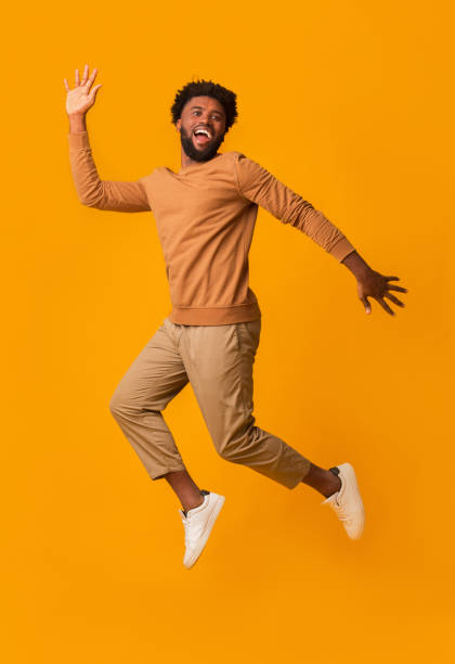istock Funny laughing afro guy jumping in the air 2178373897