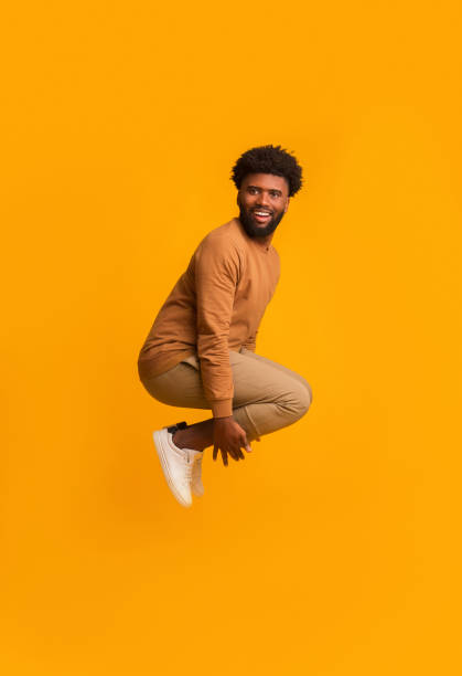 istock Emotional black guy jumping in bomb style and smiling 2178373912