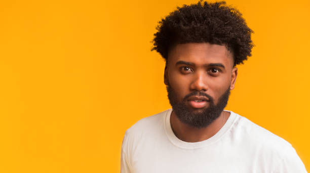 istock Portrait of hot afro guy over orange background 2178373914