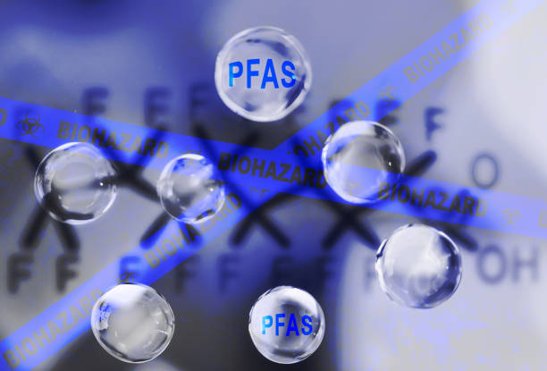 Water droplets with a PFAS chemical structure and Biohazard text-- contaminated drinking water concept