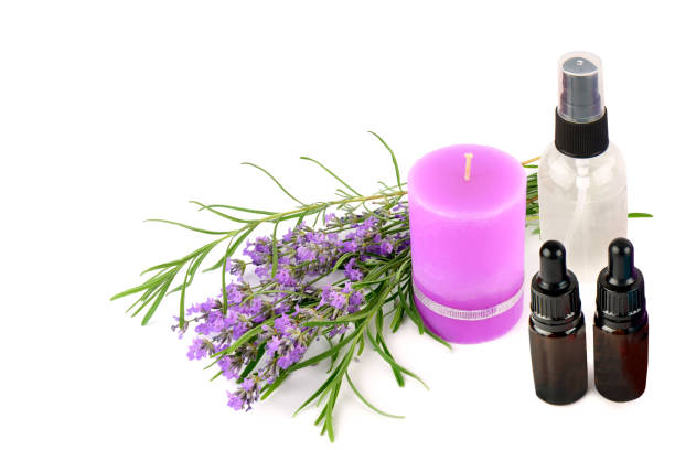 Lavender candle and lavender oil isolated on white background. Free space for text. Collage.