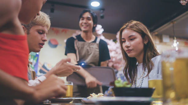 istock Group of friends in a Japanese restaurant. 2178377654