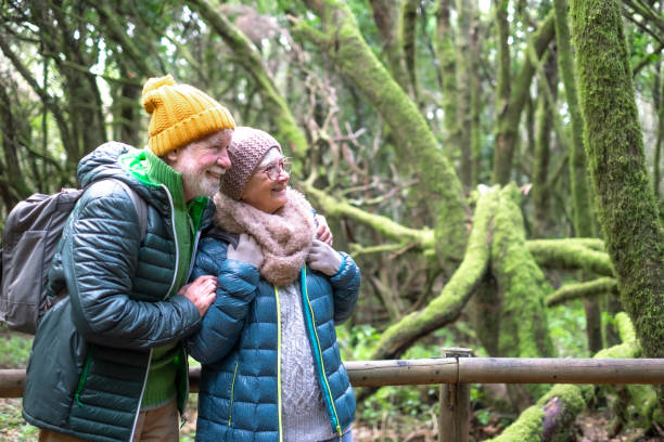 istock Affectionate active senior couple embrace in the forest, mossy tree branches in Garajonay National Park on La Gomera Island. Healthy lifestyle in retirement 2178381408