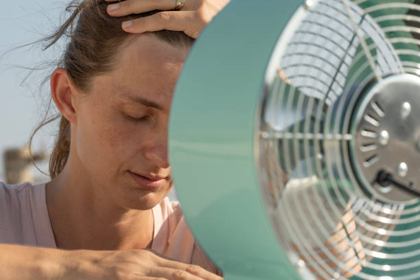 istock Woman Cooling Off in Front of a Fan 2178382847