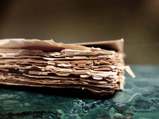 istock Old Tattered Worn Rough Paper Book or Packet of Documents Textured and Stained 2178383528