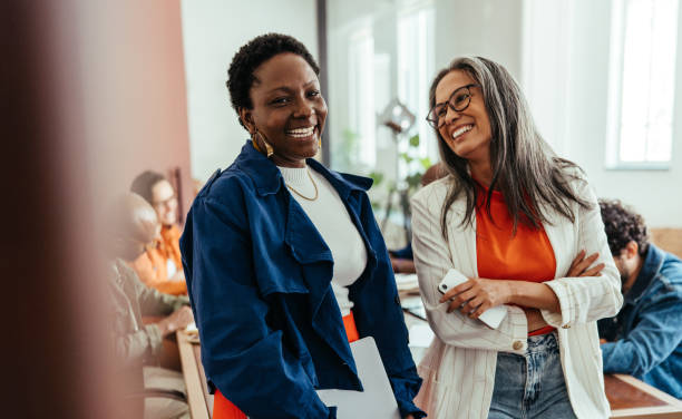 istock Creative co-working environment with diverse women colleagues chatting and laughing in a vibrant workplace 2178384339