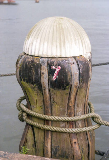 The original old historic mooring posts on the IJ river of Amsterdam that were replaced by bollards in 2010. Cultural heritage on the IJ river of Amsterdam; the original mooring posts. Cultural heritage on the IJ river of Amsterdam; the original mooring posts for shipping that stood on the quays along the water. Sumutrakade, Amsterdam