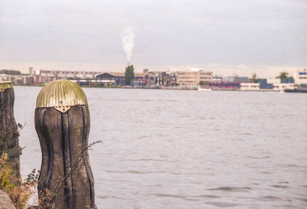 The original old historic mooring posts on the IJ river of Amsterdam that were replaced by bollards in 2010. Cultural heritage on the IJ river of Amsterdam; the original mooring posts. Cultural heritage on the IJ river of Amsterdam; the original mooring posts for shipping that stood on the quays along the water. Sumutrakade, Amsterdam