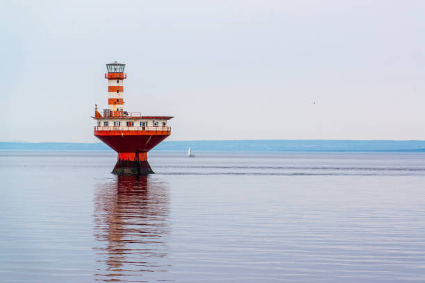 Tadoussac, Canada - July 27 2024: Lonely red Light houes in Tadoussac Bay