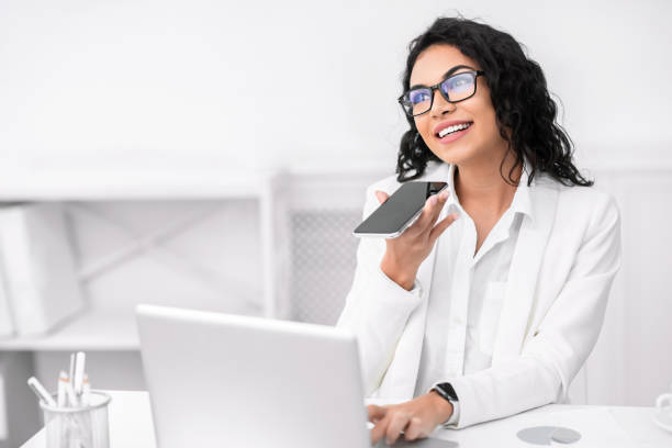 istock Pensive mexican woman using voice assistant on cellphone 2178385817