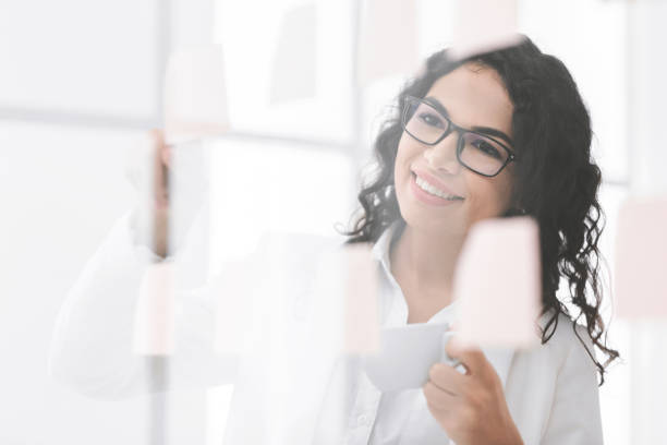 istock Brazilian woman sharing her ideas on glass wall 2178386164
