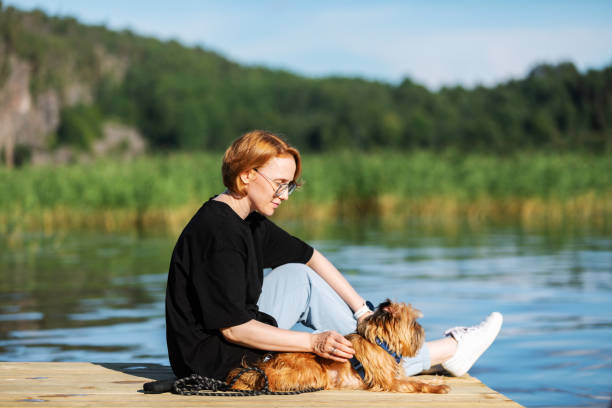 istock Mid adult woman with her Griffon Terrier 2178387630
