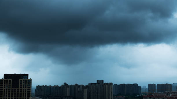 City buildings covered by dark storm clouds