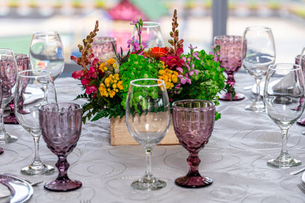 istock Celebration atmosphere with glasses, floral bouquets, chairs and a dining table 2178391216