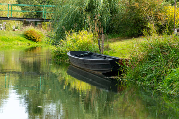 istock Spreewald germany - idyllic river landscape with old boat and mirrored trees 2178393154