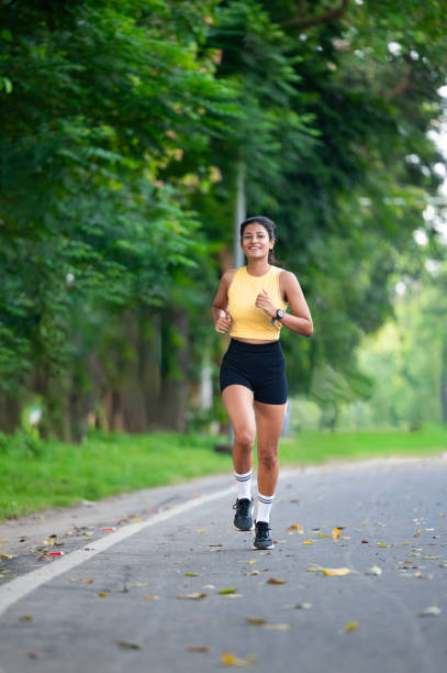 istock Young Woman Jogging in a Park on a Bright Day 2178393761