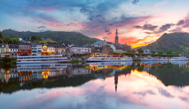 Sunset view of Cochem with Saint Martin Church, colorful buildings, and reflections, Germany