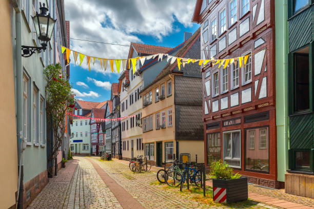 Quiet street with half-timbered houses and festive decorations in Marburg, Germany, on a cloudy day