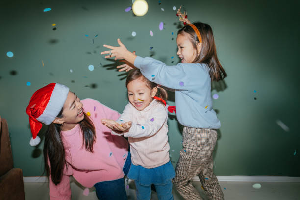 istock Mother and daughters having fun on Christmas Day 2178395938