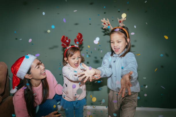 istock Mother and daughters having fun on Christmas Day 2178395959