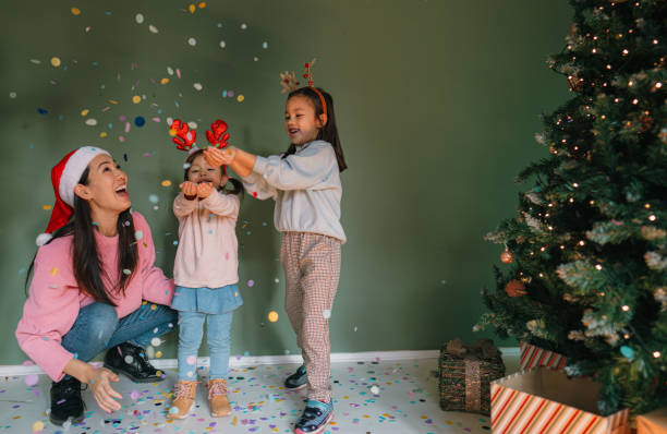 istock Mother and daughters having fun on Christmas Day 2178395967