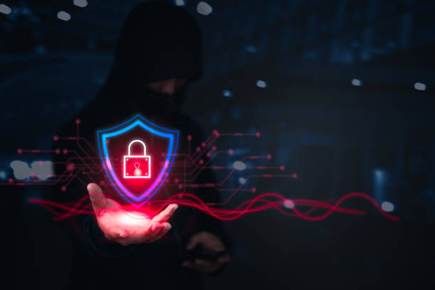 istock A hacker holds a glowing shield with a digital lock, representing cyber protection or breach. 2178396342