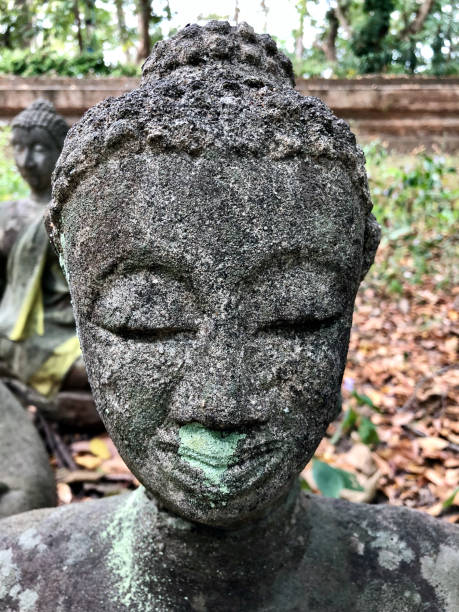 istock CU crumbling Thai Buddha head with lichens at Wat Umong 2178398924