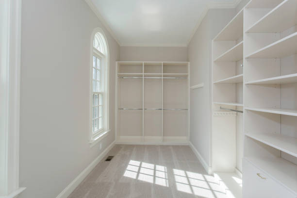 istock Bright Walk-In Closet With Built-In White Shelving Units 2178399648