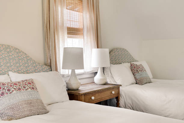 istock Twin Beds With Floral Headboards And Warm Lighting 2178400694