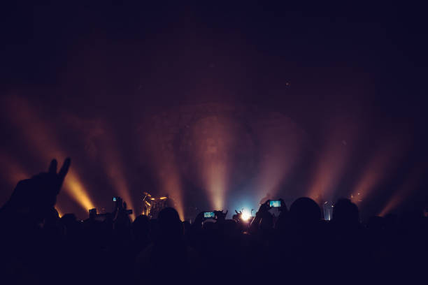 Immerse yourself in the electrifying atmosphere of an exhilarating live concert illuminated by stunning light displays