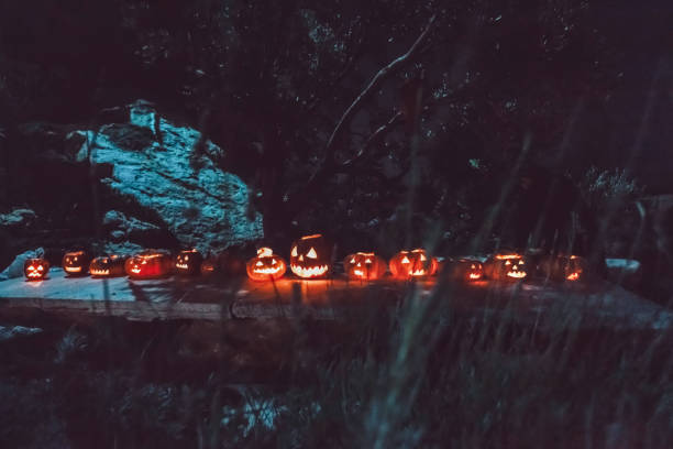 istock Spooky Halloween Night with Glowing Jack-o-Lanterns illuminating the darkness 2178401107
