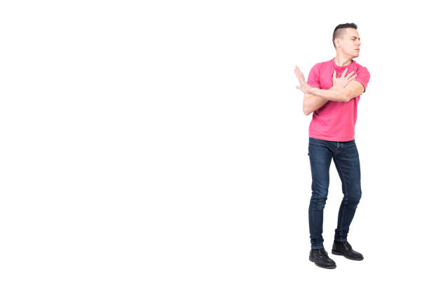 Side view of aged 12-13 years old caucasian teenage boys standing in front of white background who is contemplating