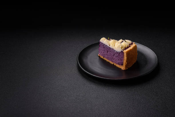 No baked sweet blueberry cheesecake with cream cheese on a dark texture background