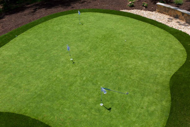 istock Manicured Putting Green With Flags And Clubs. 2178405177