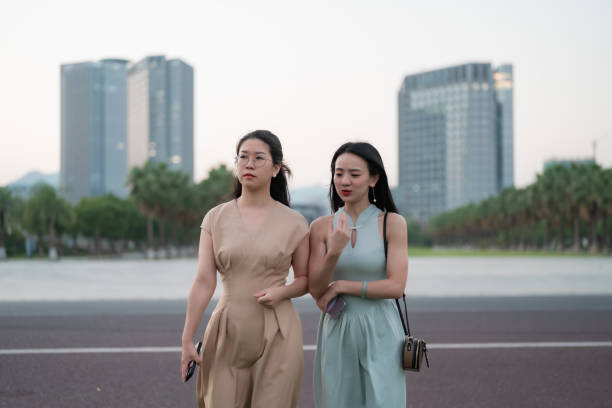 Two business ladies discussing business outdoors at sunset