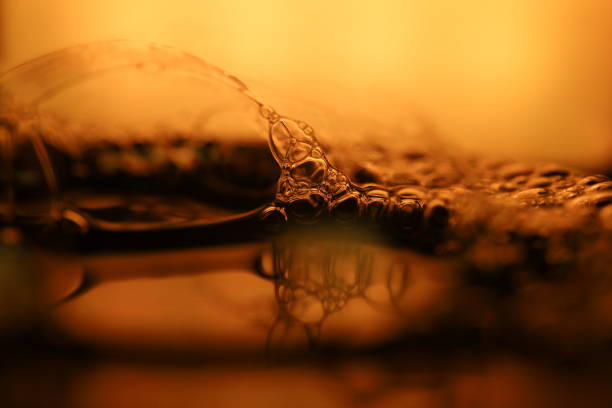 Colored oil bubbles greys and purles floating in water
