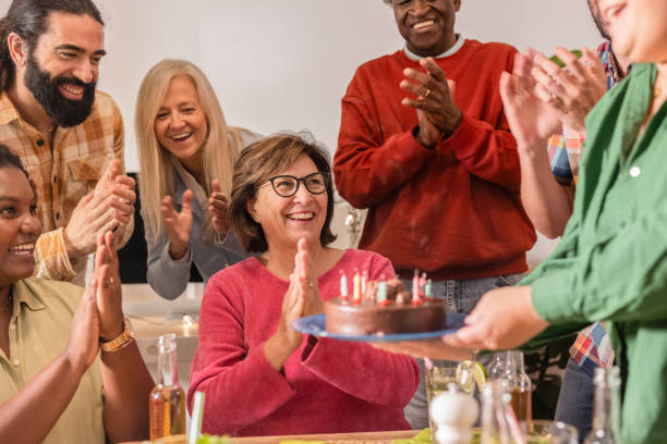 istock Diverse group clapping celebrating birthday with cake and candles 2178406664