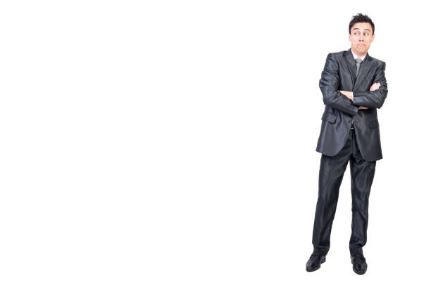 Mature executive in a sharp suit finds peace and balance by taking a deep breath and closing their eyes in the office. The blue hues add to the calm atmosphere