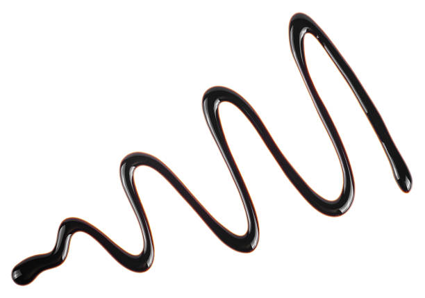 Chocolate syrup drizzle isolated on a white background. Splashes of sweet chocolate sauce. Choco sauce drop.
