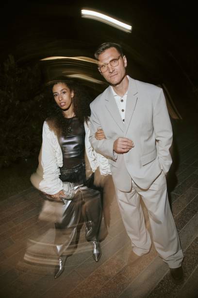 istock Multiethnic Celebrity Couple in Silver Gray Outfits Posing for Camera at Night Event 2178408020