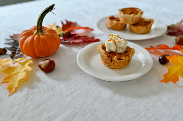 istock Fall harvest thanksgiving dinner with pumpkin dessert at decorated table 2178409018