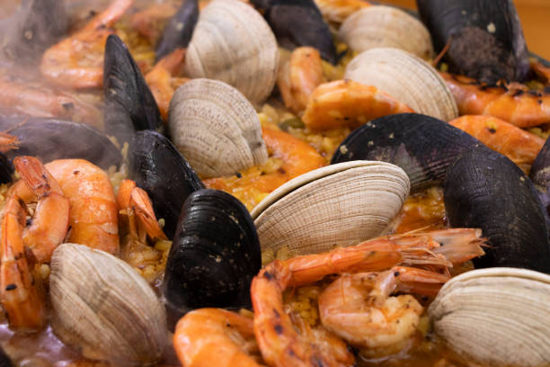 Spanish paella. White background, green textures and blue napkin