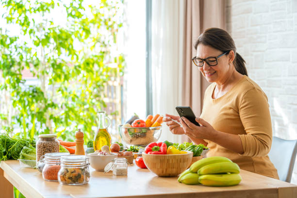 istock Woman using phone while having healthy meal at home 2178411111