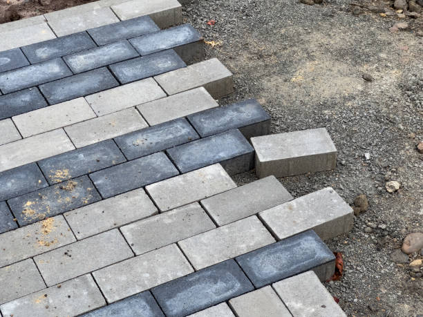 istock Workers carefully lay the paving stones in a pattern to construct a robust pavement at a construction site, ensuring precise alignment for durability 2178411437