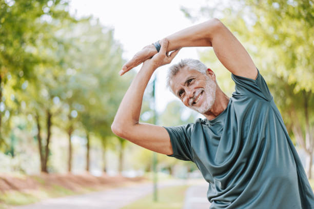 istock Old man doing stretching in public park 2178412987