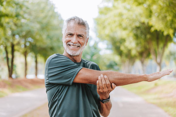 istock Senior man doing stretching in public park 2178413000