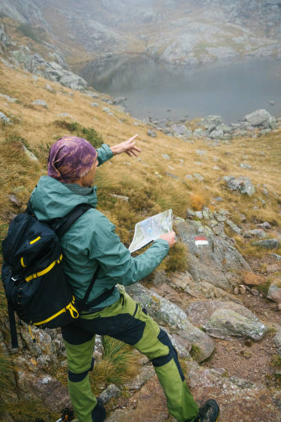 istock Hiker checking the map to orient himself during a mountain hike 2178413008