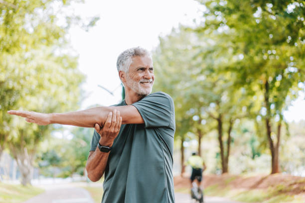 istock Senior man doing stretching in public park 2178413009