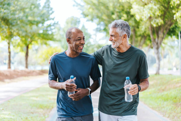 istock Senior friends walking in public park 2178413164